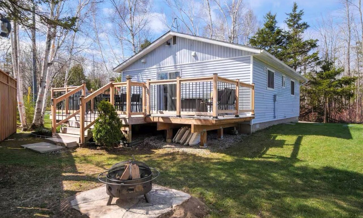 Miller Lake House | Updated 2-bed, 4-season cottage on a private lot across from crystal-clear Miller Lake. Relax by the wood fireplace, cook in a modern kitchen, and enjoy the deck and fire pit. Minutes to Lion’s Head, Tobermory and the Bruce Trail.