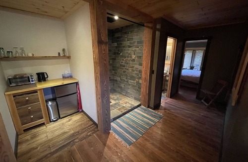 Proctor Bed & Breakfast | Loki Suite Private floor with a King size bed on the view side of the lodge.