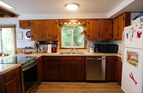 Naples Ski Chalet | Long Lake chalet and guest house with 200' of water frontage and sunset views