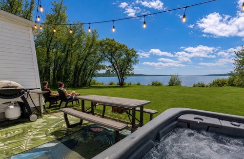 Ste Anne de Beaupre Apartment | Riverside Condo w/Private Hot Tub & Mountain
