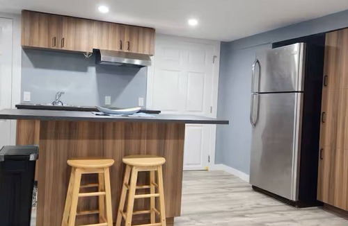 Mount Pearl House | Salt and Spruce private 1 bedroom suite with double bed, kitchen, and laundry