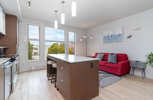 Downtown Victoria Condo | Sleek Kitchen Island and Garden Views