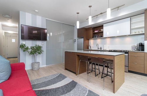 Downtown Victoria Condo | Sleek Kitchen Island and Garden Views