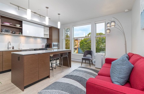 Downtown Victoria Condo | Sleek Kitchen Island and Garden Views