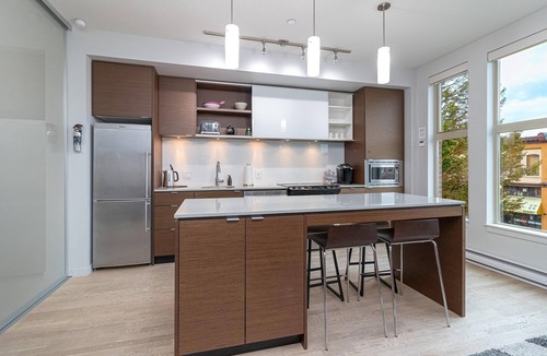 Downtown Victoria Condo | Sleek Kitchen Island and Garden Views