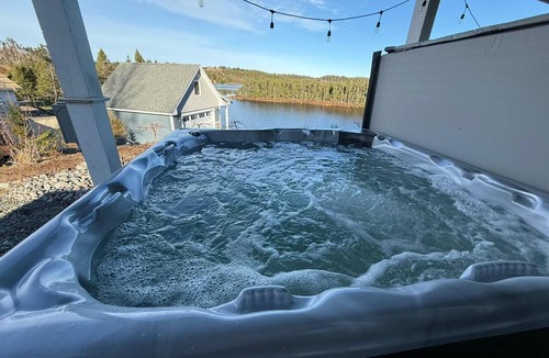 Whitbourne House | Where unforgettable weekends begin. Gather with family and friends in this spacious waterfront Lake house featuring a hot tub, stunning sunset views, and room for everyone to reconnect and celebrate.