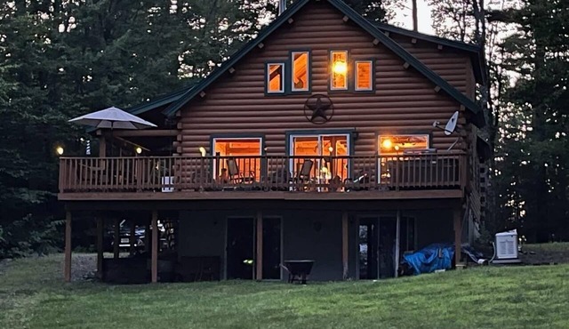 Beautiful lakefront 4-bedroom log home on 2 acres with sandy beach, private dock