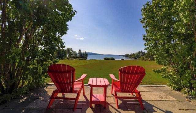 Two lakefront dog-friendly cabins on four acres with porches, dock, & lake views